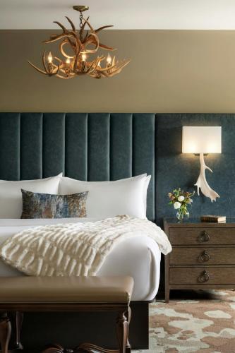a bedroom with a bed and a chandelier at Grand Bohemian Lodge Asheville, Autograph Collection in Asheville