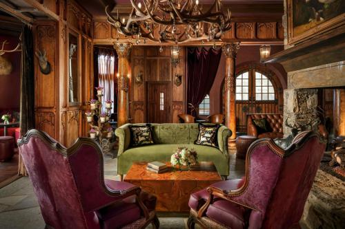 a living room with a couch and a table at Grand Bohemian Lodge Asheville, Autograph Collection in Asheville