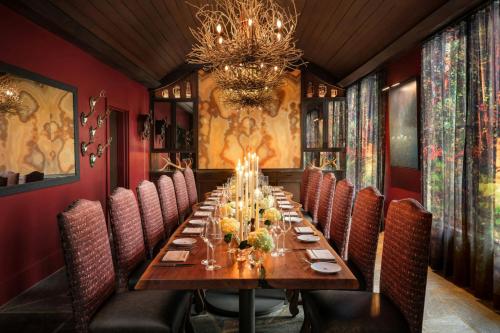 a dining room with a long table and chairs at Grand Bohemian Lodge Asheville, Autograph Collection in Asheville
