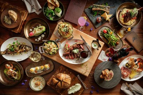 a wooden table with plates of food on it at Grand Bohemian Lodge Asheville, Autograph Collection in Asheville