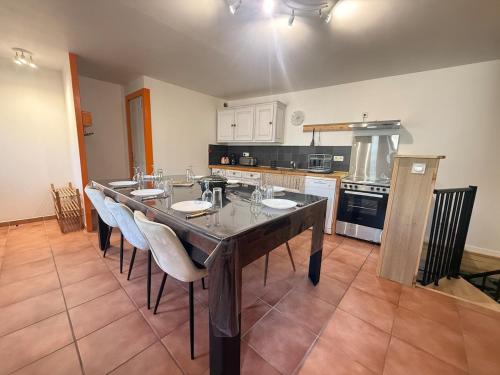 a dining room with a table and chairs in a kitchen at L' Altitude Billard Proche Stations Cols in Saint-Michel-de-Maurienne