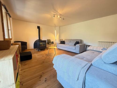 a living room with a bed and a couch at L' Altitude Billard Proche Stations Cols in Saint-Michel-de-Maurienne