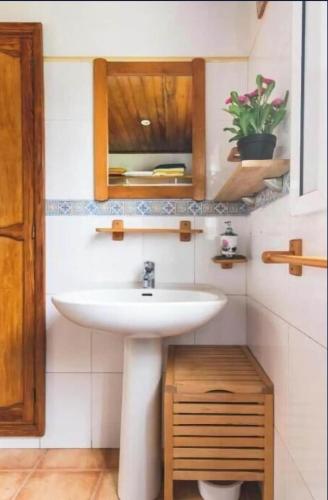 a bathroom with a white sink and a mirror at Las Terrazas Valleseco in Valleseco