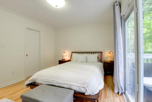 a bedroom with a bed and a large window at Cozy Cary Abode about 10 Mi to Downtown Raleigh! in Cary
