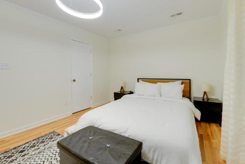 a white bedroom with a large bed with white sheets at Cozy Cary Abode about 10 Mi to Downtown Raleigh! in Cary
