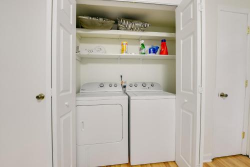 a kitchen with white cabinets and white appliances at Cozy Cary Abode about 10 Mi to Downtown Raleigh! in Cary