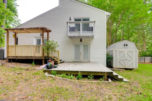 a small white house with a porch and a deck at Cozy Cary Abode about 10 Mi to Downtown Raleigh! in Cary