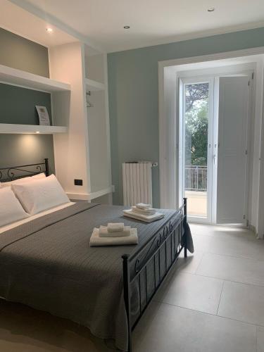 a bedroom with a bed with two towels on it at B&B Ai Templi Paestum in Stazione di Paestum