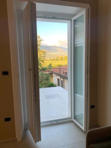 a sliding glass door with a view of a balcony at B&B Ai Templi Paestum in Stazione di Paestum