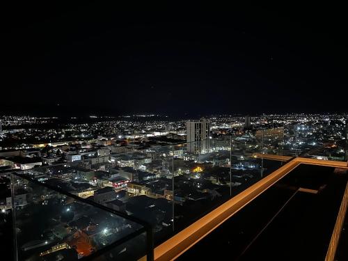 a view of a city at night with lights at Apartamentos Exclusivos no Edifício City House in Barreiras