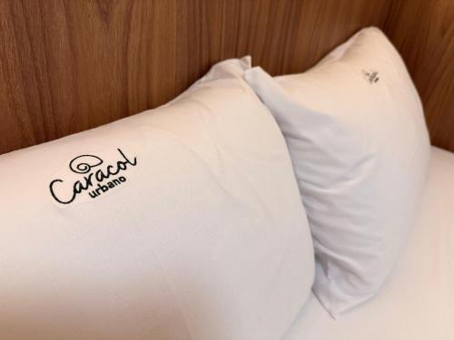a white pillow with the word california on it at Apartamentos Exclusivos no Edifício City House in Barreiras