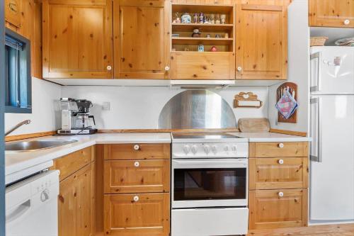 a kitchen with wooden cabinets and a stove top oven at BV316-Esbjerg-V-Ovre-Bulbjergvej-6 in Esbjerg