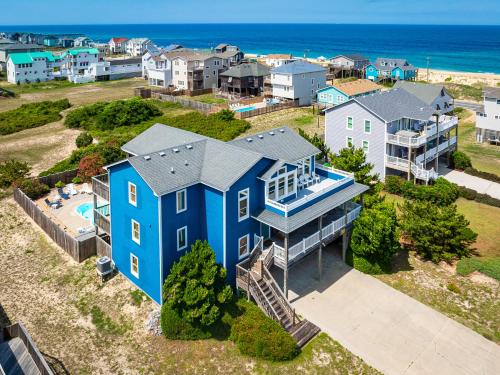 an aerial view of a blue house with the ocean in the background at H&H III - K0020 in Kitty Hawk