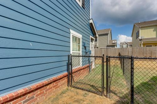 a blue house with a fence in front of it at Poolside Bliss and Lake Fun Monkey Island Retreat! in Afton