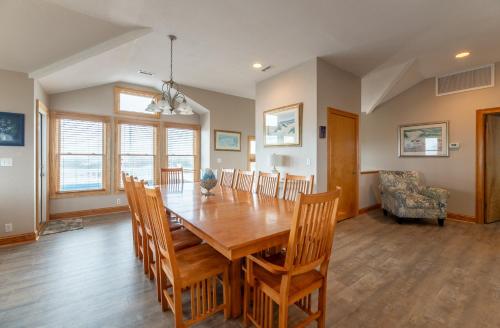 a dining room with a wooden table and chairs at H&H III - K0020 in Kitty Hawk