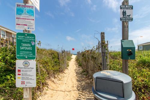 a road with a tv and signs on it at H&H III - K0020 in Kitty Hawk