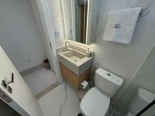 a small bathroom with a toilet and a sink at Apartamentos Exclusivos no Edifício City House in Barreiras