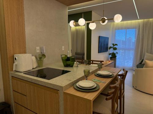 a kitchen with a sink and a counter with plates on it at Apartamentos Exclusivos no Edifício City House in Barreiras