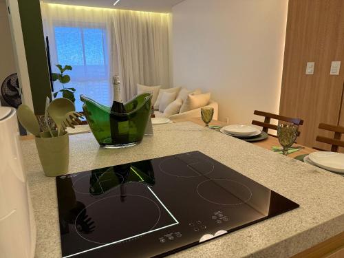 a kitchen counter with a tablet on top of it at Apartamentos Exclusivos no Edifício City House in Barreiras