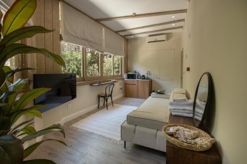 a living room with a couch and a kitchen at Numero CINQ Fragrance Boutique Hotel in Cairo