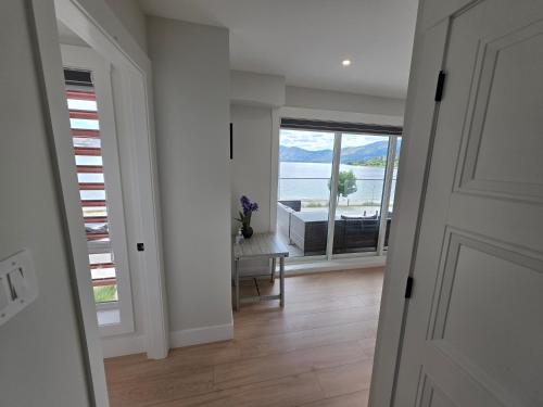 a door to a room with a view of the water at Premium Deluxe PeachView Suites 3BR in Peachland