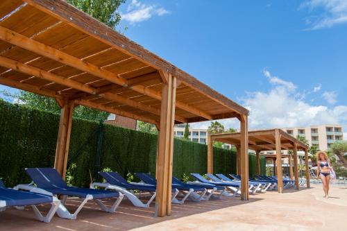 a group of chairs under a pavilion at a resort at RVHotels Ametlla Mar in L'Ametlla de Mar