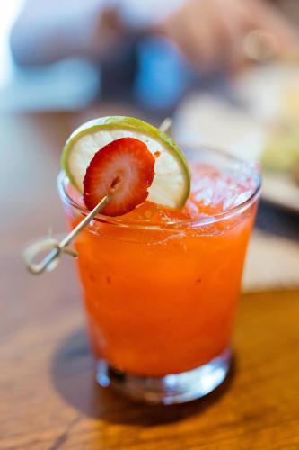 a drink with a strawberry and a lime on top at The Westin Monache Resort, Mammoth in Mammoth Lakes