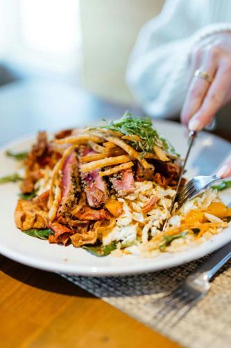 a plate of food with a salad on a table at The Westin Monache Resort, Mammoth in Mammoth Lakes