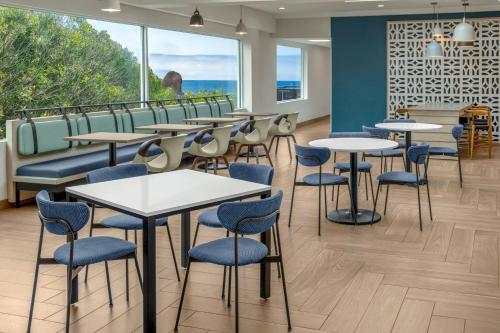 a cafeteria with tables and chairs and a large window at Fairfield by Marriott Inn & Suites San Francisco Pacifica in Pacifica