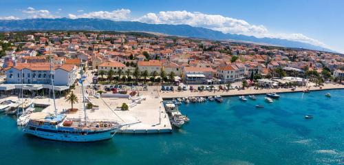 an aerial view of a town with boats in the water at Pool Studio near Sea in Novalja