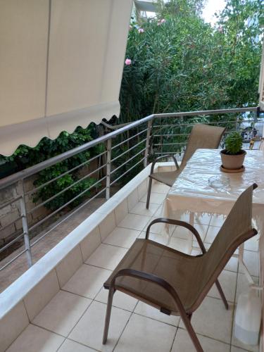 a patio with a table and chairs on a balcony at Konnie Seaside House 2 in Diakopto