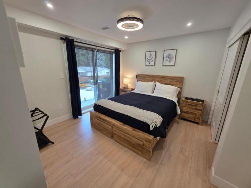 a bedroom with a bed and a large window at Premium Deluxe PeachView Suites 3BR in Peachland