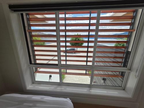 a large window in a bedroom with a view at Premium Deluxe PeachView Suites 3BR in Peachland