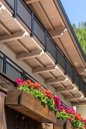 a balcony with flowers in a wooden box at Haus Gstrein in Obergurgl