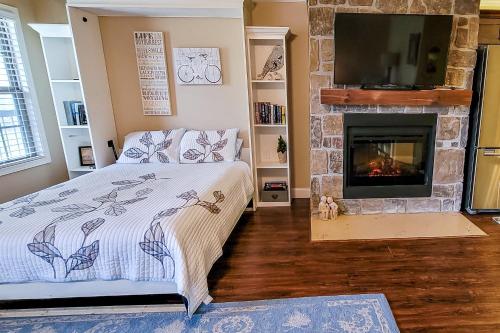 a bedroom with a bed and a fireplace at Riverfront Gem in Townsend