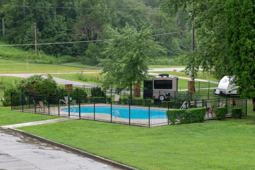 a fence with a pool in a yard with a rv at Riverfront Gem in Townsend