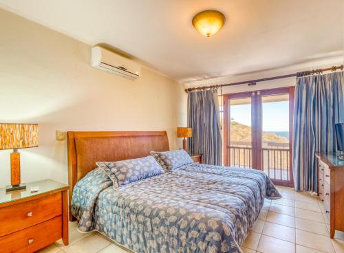 a bedroom with a bed and a balcony at Bahia Pez Vela Villa at 26 in Ocotal