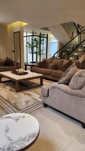 a living room with couches and a coffee table at فيلا ابها 3 in Abha