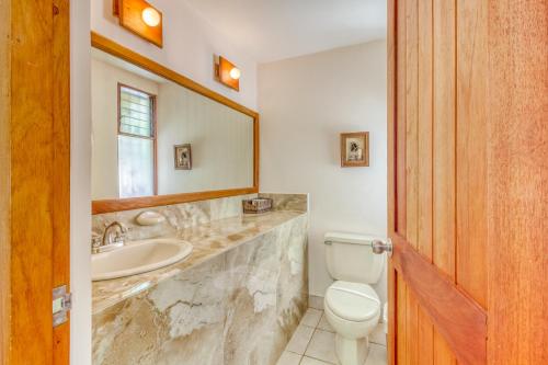 a bathroom with a sink and a toilet and a mirror at Bahia Pez Vela Villa at 18 in Ocotal