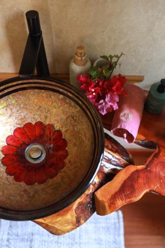 a bowl with a painting of a flower on a table at Casa Klod Ibiza in Ibiza Town