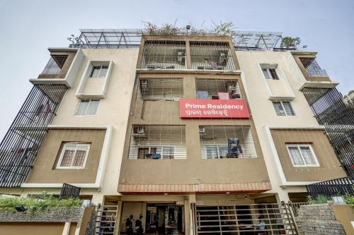 a tall building with a red sign on it at Super Capital O Sayhallo Prime Residency in Bhubaneshwar