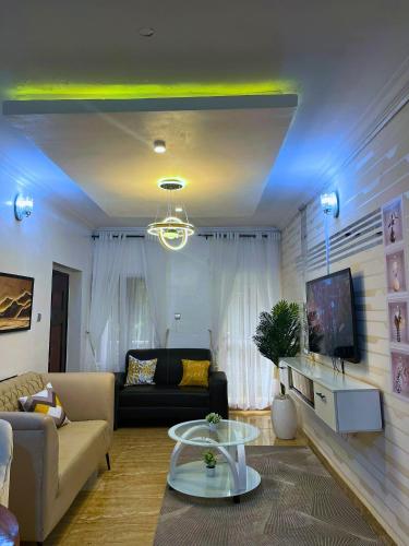 a living room with a couch and a table at Luxury 1&2 Bedrooms Apartment Ikeja Lagos Core, Family, Business, Leisure, 24h Power&Water, Fast WiFi, Two Balconies, Spacious Living, Easy Transport,Just 10min to GRA&SHOPRITE in Ikeja