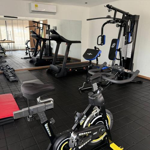 a gym with several tread machines and a bike at VillaFatima in Rivera