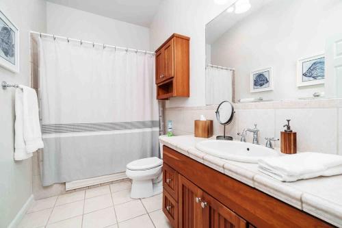 a bathroom with a sink and a toilet at Northshore Oceanfront Home- 5 bedroom and 4 bath in Waialua