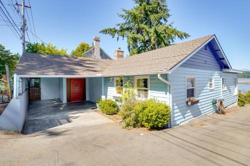 a small white house with a red door at Across Water From Belfair SP Hood Canal Cottage! in Belfair