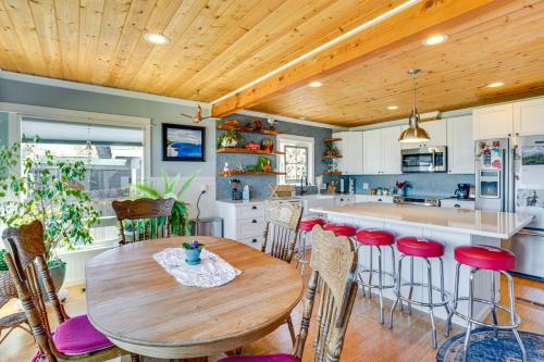 a kitchen with a wooden ceiling and a wooden table at Across Water From Belfair SP Hood Canal Cottage! in Belfair