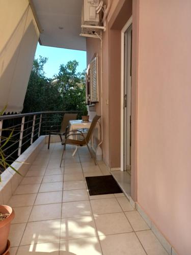a balcony with a table and chairs on it at Konnie Seaside House 2 in Diakopto
