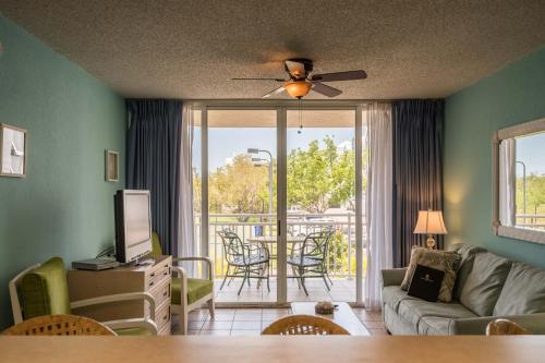 a living room with a couch and a table with chairs at Sunrise Suites Cozumel Suite #112 in Key West