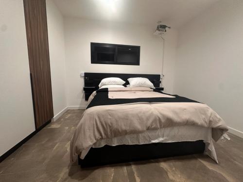 a bedroom with a bed and a flat screen tv at Ruelle 505 in Tijuana
