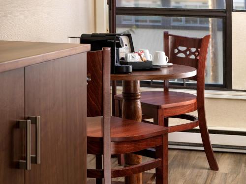 a kitchen with a small table with a coffee maker at Huntingdon Hotel and Suites in Victoria